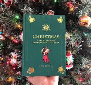 Green hard cover Christmas book about history of Christmas, Solstice and Santa by Andy Thomas